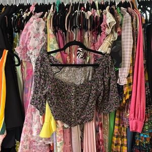 Black top with purple floral print.